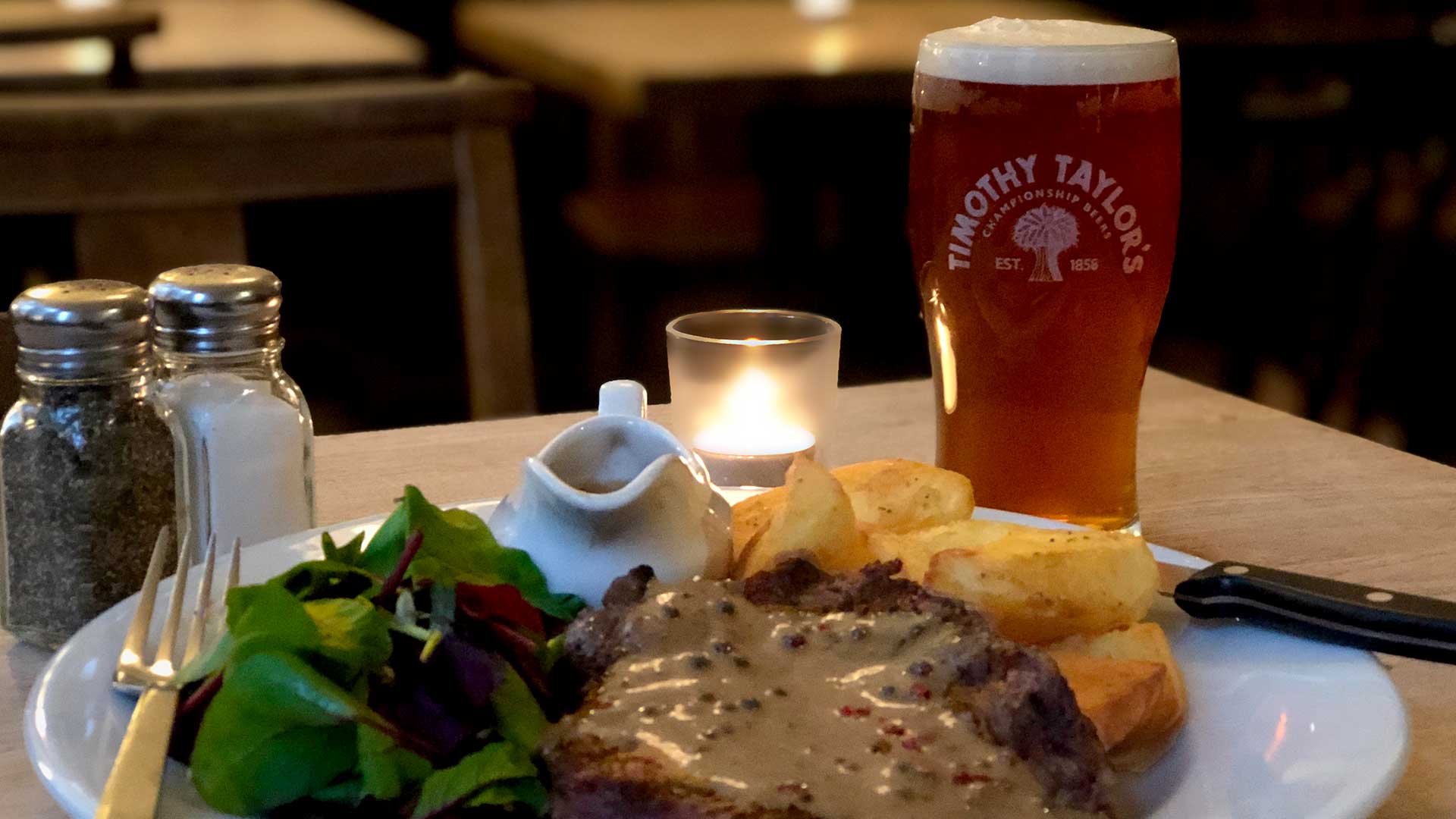Steak and chips with a pint of Timothy Taylor Landlord at The Harrison Pub Kings Cross